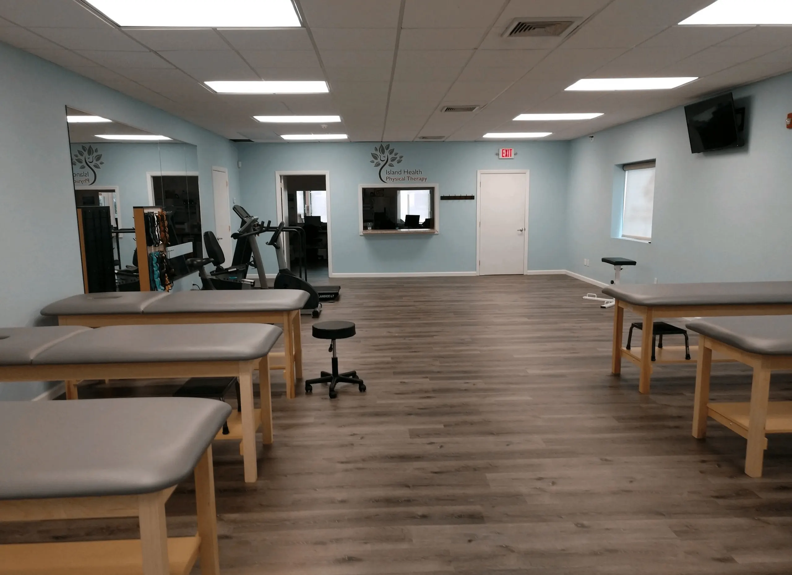Treatment tables and exercise equipment inside Island Health Physical Therapy in Riverhead