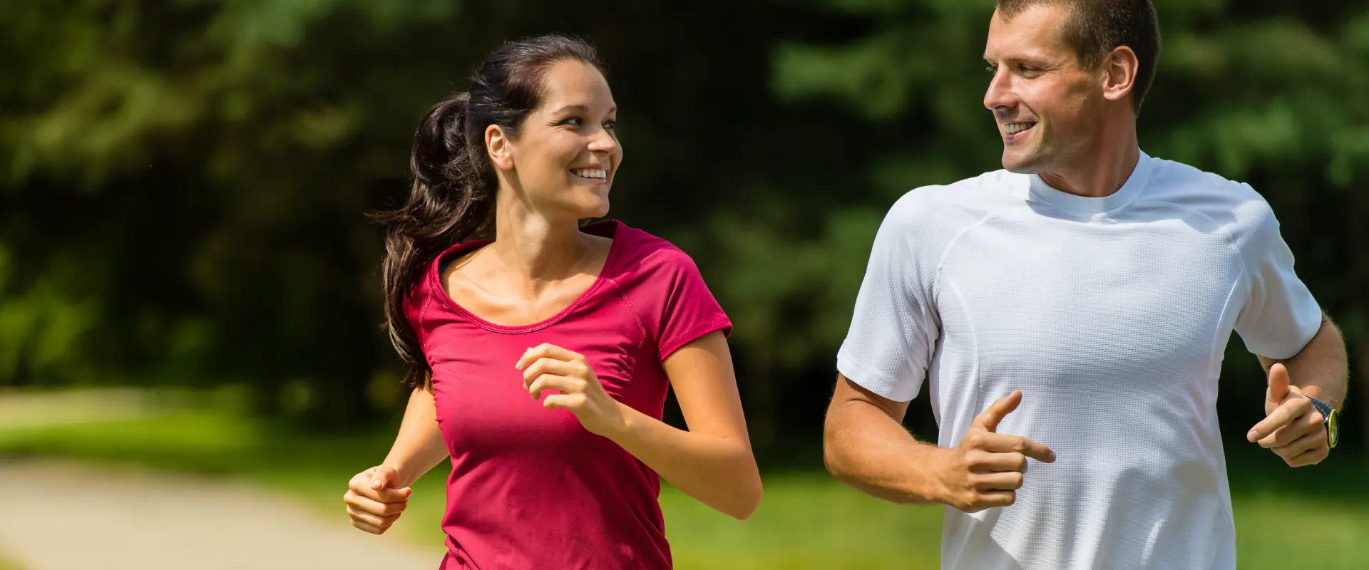 Two runners jogging outdoors after physical therapy